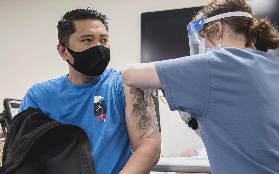 Petty Officer 1st Class Antonio Ledesma receives the Moderna coronavirus vaccine at  Naval Air Facility Atsugi, Japan, May 7, 2021. 