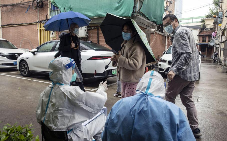 Residents take part in a round of Covid-19 testing during a lockdown in Shanghai on April 14, 2022. 