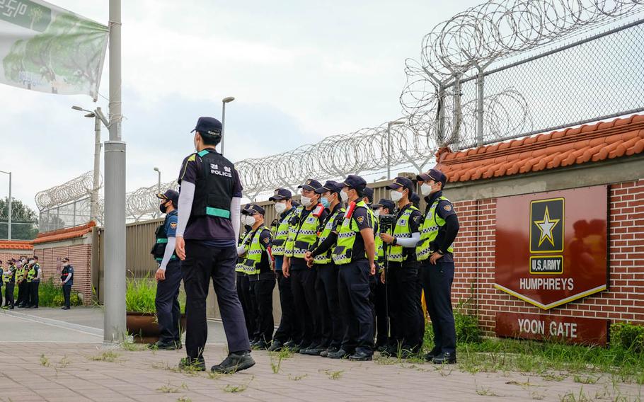 South Korean police stand guard during a protest outside Camp Humphreys, South Korea, Friday, Aug. 14, 2020. 