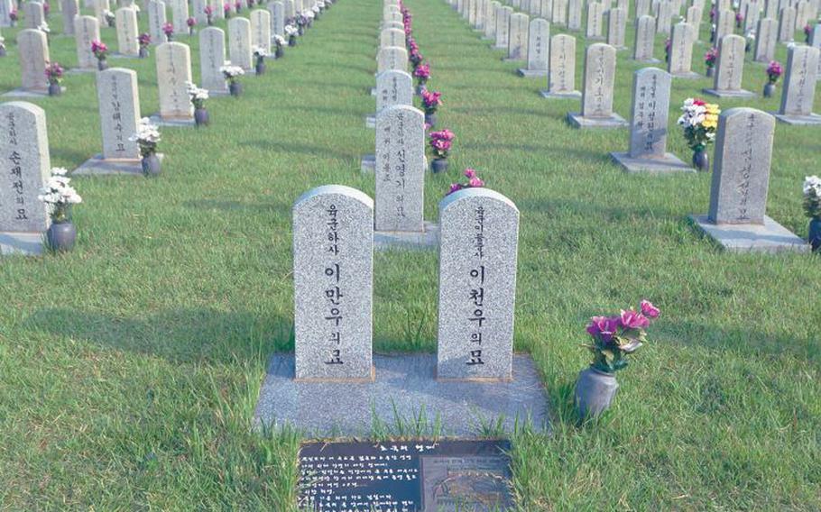 The graves of two South Korean brothers who died while fighting in the Korean War are pictured in 206 at the National Cemetery in Seoul.