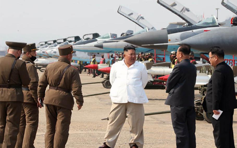 North Korean leader Kim Jong Un inspects fighter jets in a western area as shown in photos released Sunday, April 12, 2020, by the state-run Korean Central News Agency.