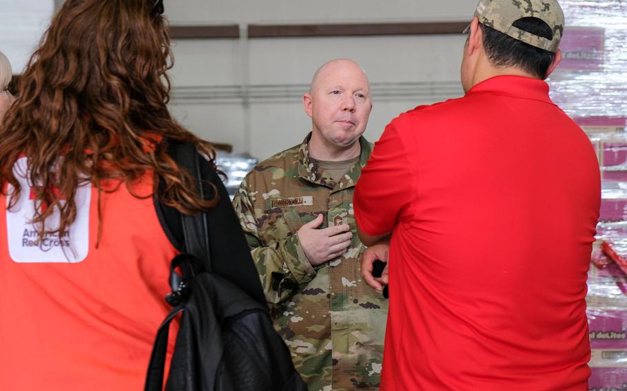 Chief Master Sgt. Brandon Dunston, a superintendent with the 7th Air Force, speaks with members of the American Red Cross at Osan Air Base, South Korea, Aug. 21, 2020. 
