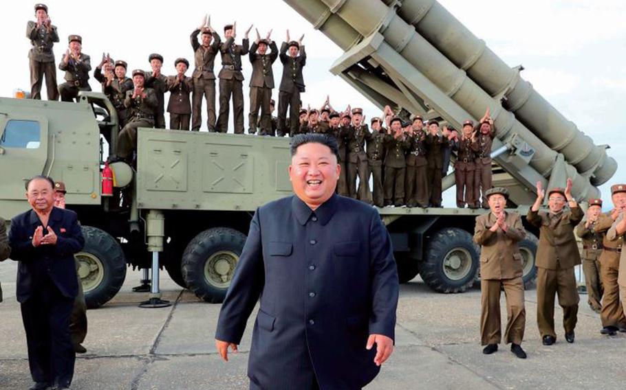 North Korean leader Kim Jong Un smiles in front of a missile launcher in this undated photo from the state-run Korean Central News Agency. 