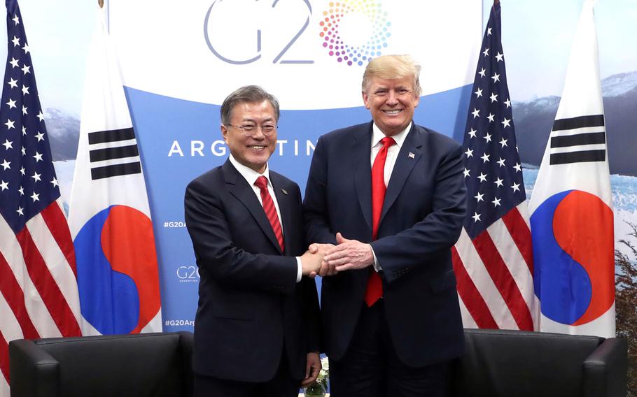 South Korean President Moon Jae-in, left, shakes hands with U.S. President Donald Trump during a meeting on the sidelines of the Group of 20 Leaders' Summit in Buenos Aires, Argentina, Nov. 30, 2018.