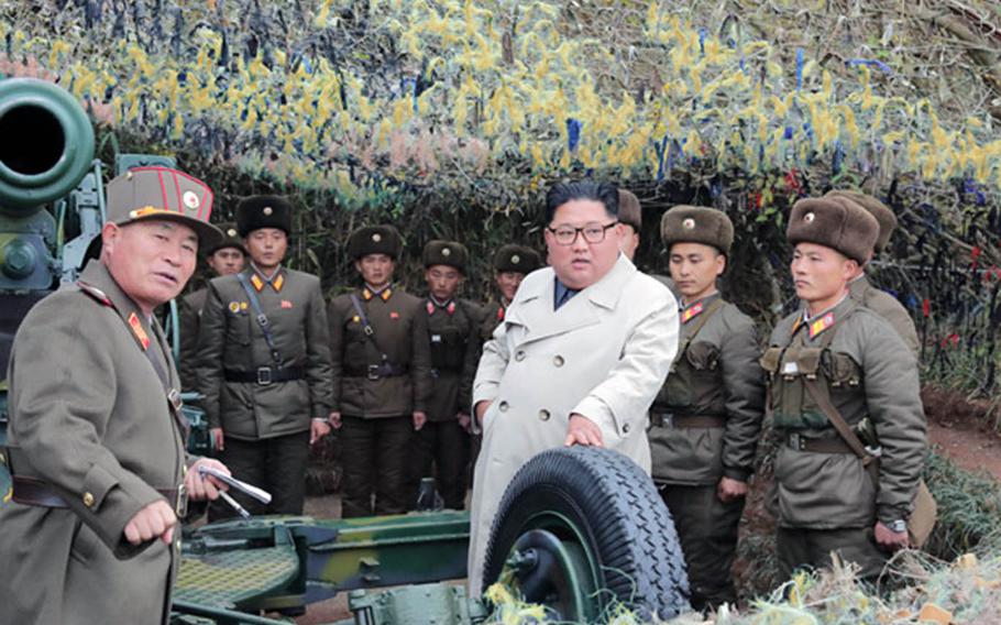 North Korean leader Kim Jong Un, center in white coat in an undated photo released Nov. 25, 2019, met with soldiers during a visit to Changrin islet near the disputed sea border off the Korean peninsula's west coast.