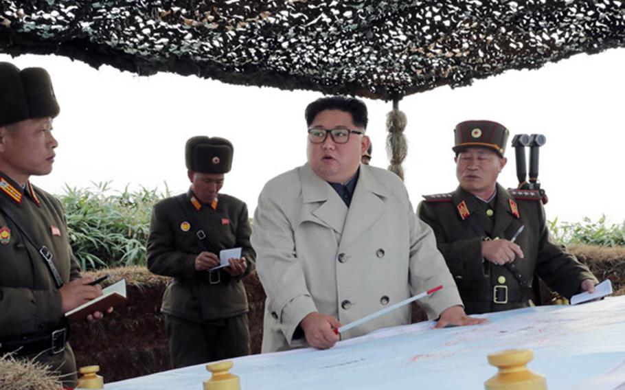 North Korean leader Kim Jong Un, center in white coat in an undated photo released Nov. 25, 2019, met with soldiers during a visit to Changrin islet near the disputed sea border off the Korean peninsula's west coast.