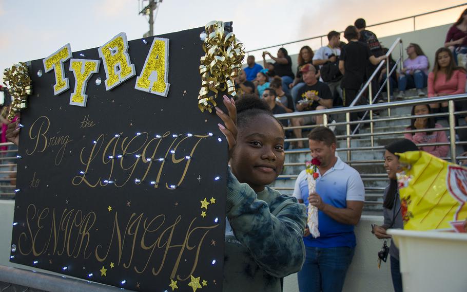 A fan raises a sign during a matchup between the Kadena Panthers and the Nile C. Kinnick Devils at Kadena Air Base, Okinawa, Friday, Oct. 18, 2019. 