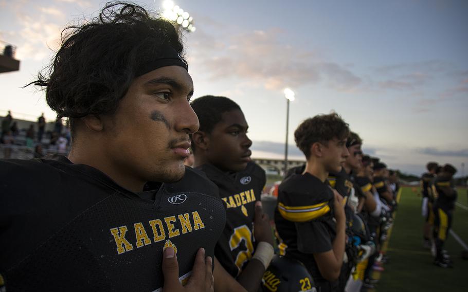 Kadena Panthers players stand during the national anthem ahead of their game against the Nile C. Kinnick Devils at Kadena Air Base, Okinawa,  Friday, Oct. 18, 2019. 