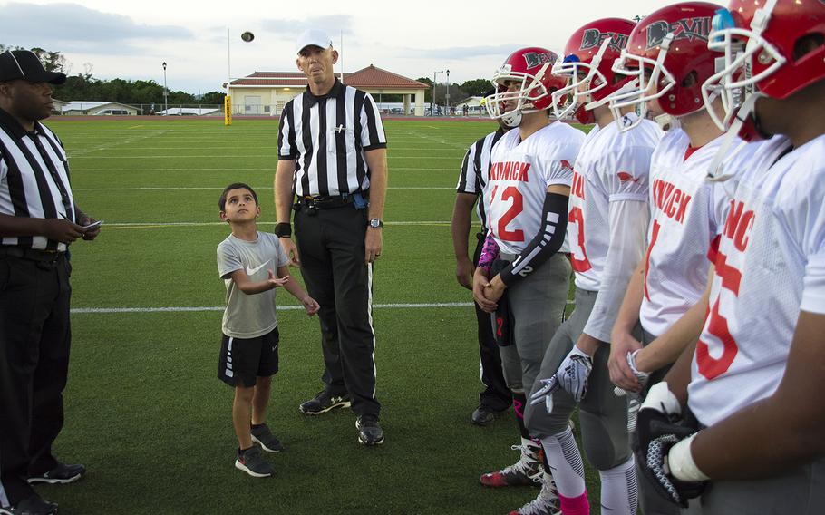 A coin is flipped on Habu Field ahead of a matchup between the Kadena Panthers and the Nile C. Kinnick Devils at Kadena Air Base, Okinawa, Friday, Oct. 18, 2019. 