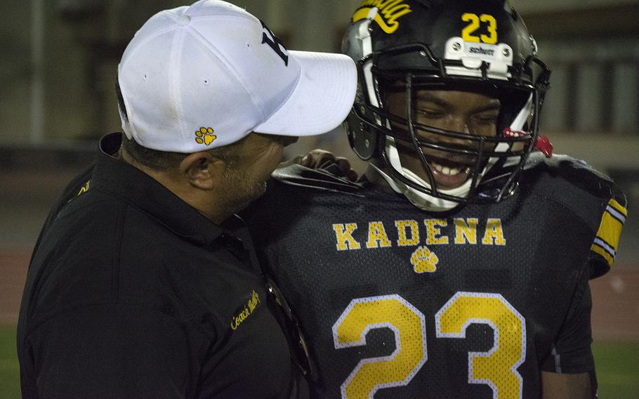 Sergio Mendoza, a coach for the Kadena Panthers, speaks to player Markell Shelton after a game against the Nile C. Kinnick Devils at Kadena Air Base, Japan, Friday, Oct. 18, 2019.