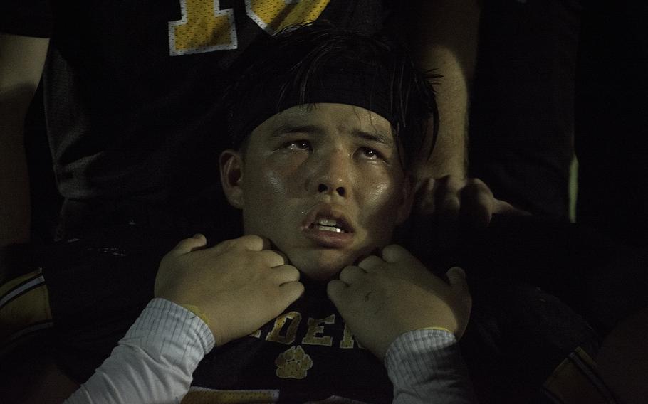 A player for the Kadena Panthers listens to a coach's speech after a game against the Nile C. Kinnick Devils at Kadena Air Base, Japan, Friday, Oct. 18, 2019. 