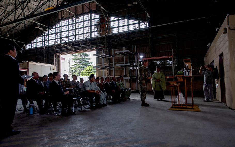 A Shinto priest prays during a ceremony inside Building 800 at Yokota Air Base, Japan, in September 2019. The 80-year-old hangar, which was once used by Japan’s Imperial Army, is being razed to make way for a new facility.