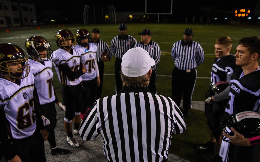 The head referee speaks to the captains of Zama American Middle-High and Matthew C. Perry High before the coin toss for their matchup at Camp Zama, Friday, Oct. 25, 2019. 