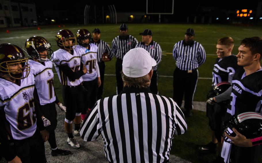 The head referee speaks to the captains of Zama American Middle-High and Matthew C. Perry High before the coin toss for their matchup at Camp Zama, Friday, Oct. 25, 2019. 