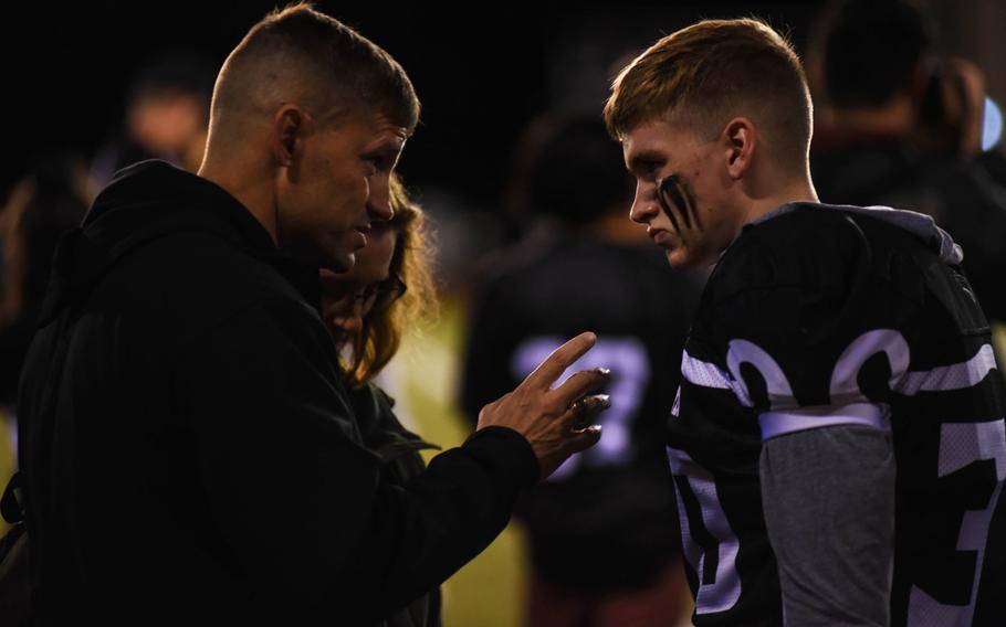 Marine Col. Michael Reilly, commanding officer of the Camp Fuji training center, gives his son, Josh, a pre-game pep talk as Zama American Middle-High School takes on Matthew C. Perry at Camp Zama, Friday, Oct. 25, 2019. 