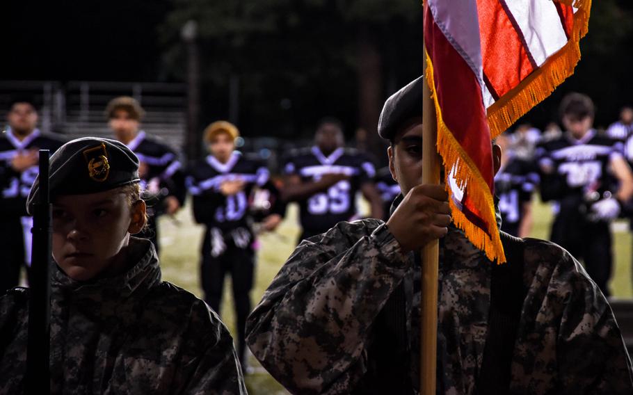 Members of Zama American Middle-High School's JROTC parade the colors during the opening ceremony for their school's matchup with Matthew C. Perry at Camp Zama, Friday, Oct. 25, 2019. 