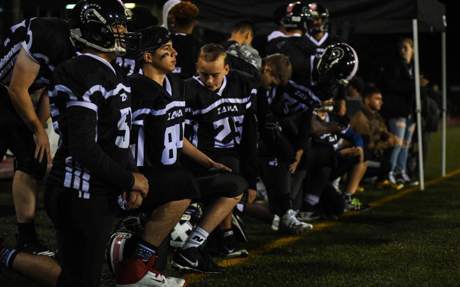 Zama American Middle-High School players take a knee after a player from Matthew C. Perry is injured during their game at Camp Zama, Friday, Oct. 25, 2019. 