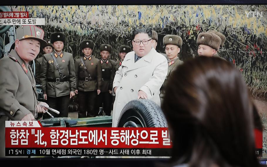 A woman watches a news program reporting North Korea's firing unidentified projectiles with a file image of North Korean leader Kim Jong Un, in Seoul, South Korea, Thursday, Nov. 28, 2019. 