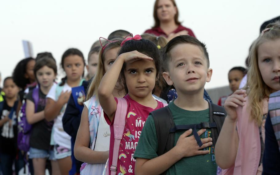 Students salute the flag during the national anthem on the first day of school at the new Vogelweh Elementary School, Monday, Aug. 26, 2019

