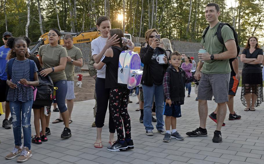 Parents wish their children a good day as they arrive for the first day of school at the new Vogelweh Elementary School, Monday, Aug. 26, 2019.  
