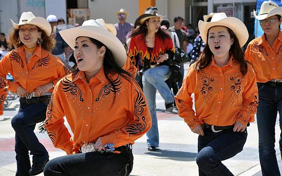 A group of Japanese line-dancers show off their skills during American Day on Sunday, June 6, 2010, outside Misawa Air Base, Japan. About 80,000 people attended the annual festival.