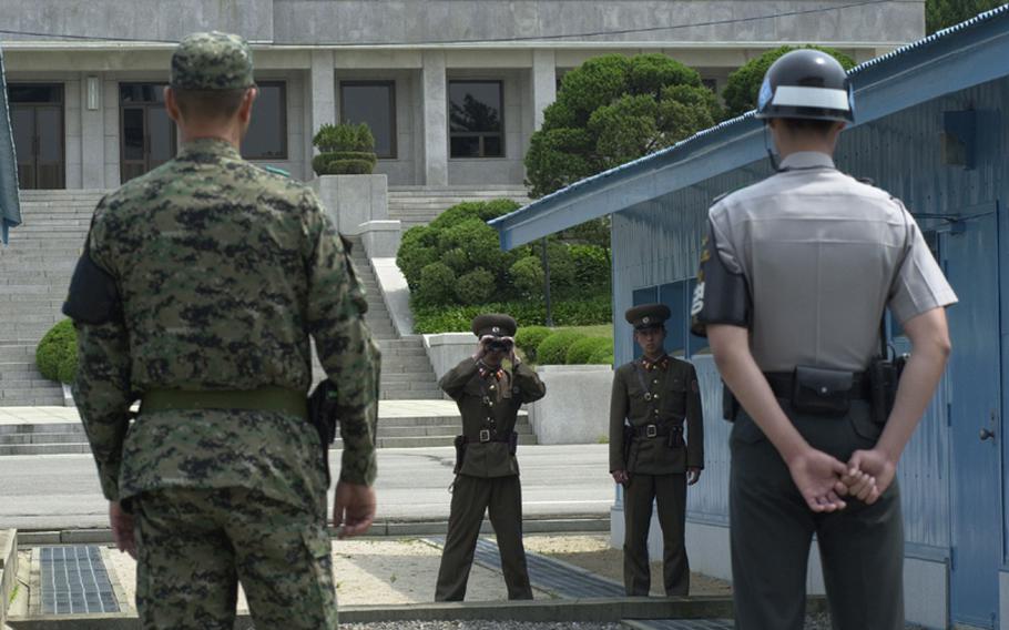Soldiers from North and South Korea stand yards apart at the DMZ in this photo from May 2009. Experts say a war of words between the two countries due to the torpedoing of a South Korean warship, blamed on North Korea, is unlikely to develop into another all-out war on the peninsula.