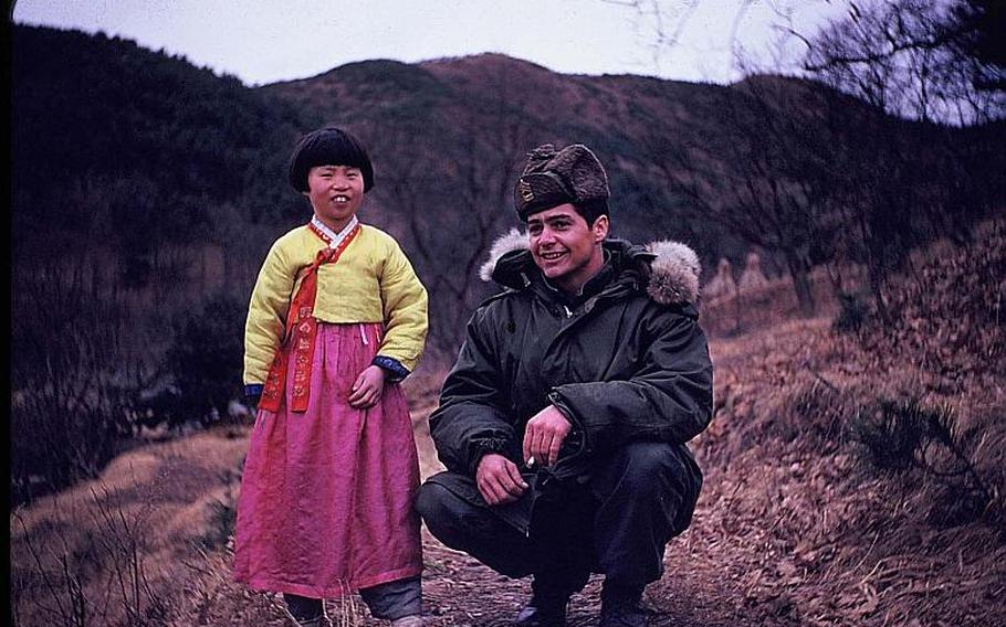 In the fall of 1953, soon after Korean War fighting ceased, then-Sgt. 1st Class Curley B. Knepp poses with a youngster about 30 miles north of Seoul. Knepp was 19 years old and assigned to Company A, 1st Battalion, 15th Infantry Regiment, 3rd Infantry Division.
