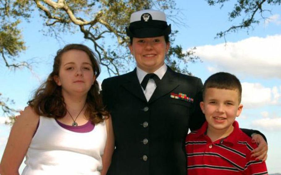 Petty Officer 1st Class Angela McCabe, seen here in 2008 with her children, Rebecca, now 15, and JJ, now 11, is fighting for custody of her children after returning to Naval Air Station Jacksonville, Fla., in April from a deployment to Cuba.