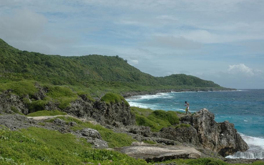 A man walks along Guam's eastern shore in an area near Pagat, the site of an ancient Chamorro village, in the summer of 2010. The military has proposed putting a firing range adjacent to the village on land stretching further north up the coast. That proposal, despite offers to keep the Pagat area accessible to the public, has not appeased some. Earlier that year, the National Trust for Historic Preservation put the area on its most endangered list.