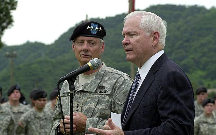 U.S. Defense Secretary Robert Gates, right, speaks to about 300 soldiers Tuesday at Camp Casey in South Korea as U.S. Forces Korea commander Gen. Walter Sharp looks on.