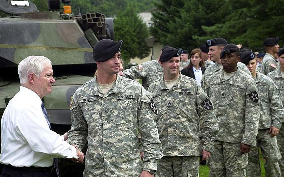 Defense Secretary Robert Gates meets and poses for photos Tuesday with members of the 2nd Infantry Division's 1st Heavy Combat Brigade during a visit to Camp Casey in South Korea.