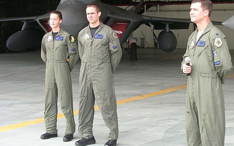 At Osan Air Base in South Korea on Monday, three Air Force pilots who fly the advanced F-22 Raptor fighter answer reporters' questions about the aircraft, two of which are parked behind them. The  Raptors will take part in this week's large-scale, naval air exercise that runs Sunday through Wednesday. From left are Maj. Jammie Jamieson, Capt. Brandon Tellez and Lt. Col. Robert Teschner. All are with the 7th Expeditionary Fighter Squadron, of which Teschner is commander.