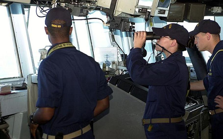 Crewmembers aboard the guided-missile destroyer USS Curtis Wilbur, based out of Yokosuka Naval Base, Japan, scan the horizon Tuesday during the Invincible Spirit military exercise the U.S. and South Korea have been staging off the east coast of the Korean peninsula. The exercise was scheduled to conclude Wednesday.