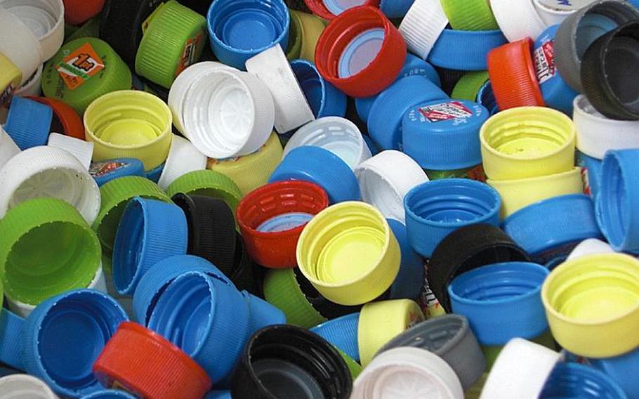 Colorful plastic bottle caps, collected by children at Cherry Blossom Preschool in Kitanakagusuku, Okinawa, are given to the Okinawa Ecological Cooperative Association for recycling. Caps are crushed into chips at a factory on Okinawa before shipping to a recycling facility in mainland Japan to be turned into a water-resistant building material that substitutes for plywood.