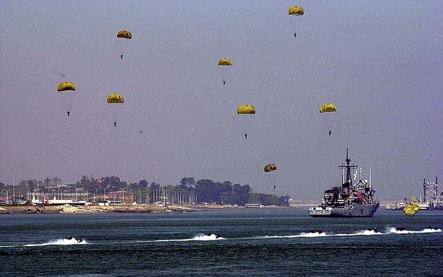 Parachutists descend from the sky during a re-enactment Wednesday of the Inchon Landing off Wolmi Island in South Korea. The event marked the 60th anniversary of the surprise attack, which was a turning point in the Korean War.