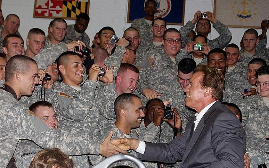U.S. soldiers shake hands with Gov. Arnold Schwarzenegger on Wednesday evening at Collier Field House at Yongsan Garrison, South Korea.