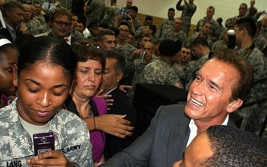 Gov. Arnold Schwarzenegger greets soldiers and family members Wednesday evening after a motivational speech at Collier Field House at Yongsan Garrison, South Korea.