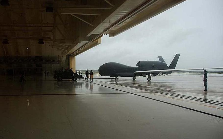 Jeff Schultze/Courtesy of the U.S. Air Force
The Air Force directs a Global Hawk unmanned aerial vehicle into a hangar at Andersen Air Force Base in Guam Monday. The drone is the first of its kind deployed to the Pacific and will enable the Air Force to surveille from the Indian Ocean to the coast of South America.