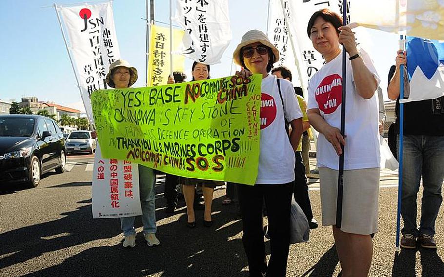 Supporters of the U.S.-Japan Secutiry Treaty take to the streets in Naha on  Monday afer a rally in downtown Naha that drew about 250 people.