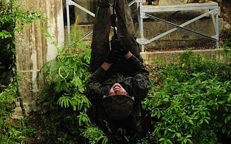 A Marine struggles against the force of gravity at the Jungle Warfare Training Center.