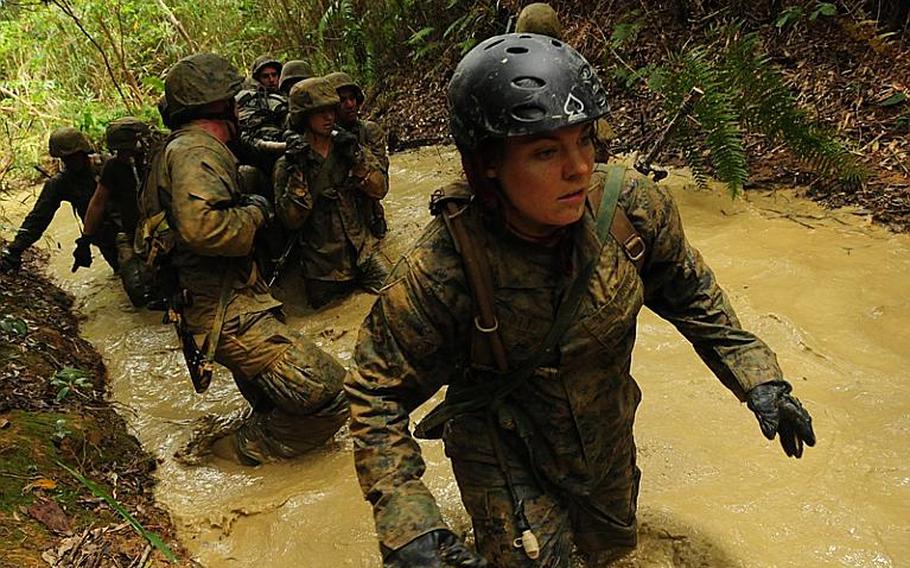 Pfc. Chelsea Ott pushes through the thick mud during the latter part of the endurance course at the Jungle Warfare Training Center on Okinawa.