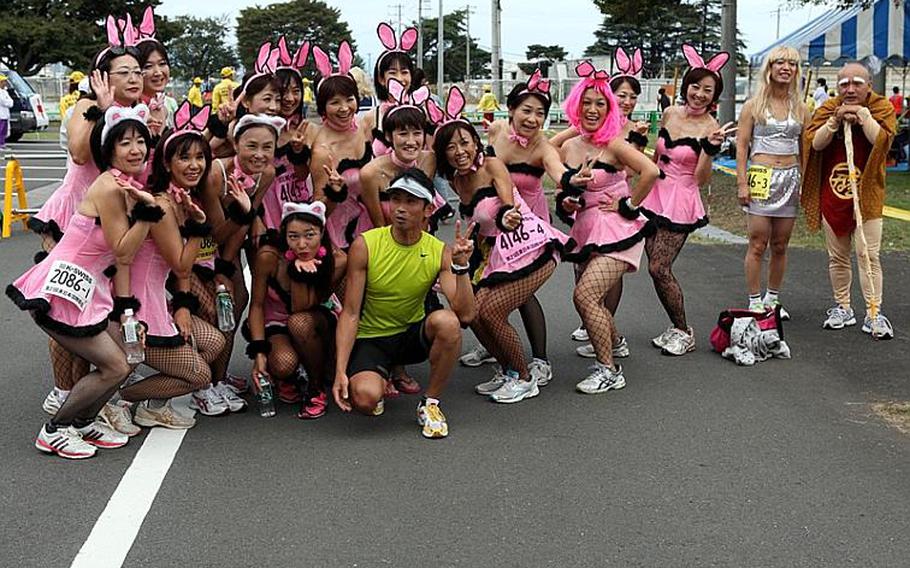 A group of runners show of their colorful costumes, which were but a small sample of costumes worn by many runners at the 21st annual Ekiden relay race Sunday at Sagami General Depot.