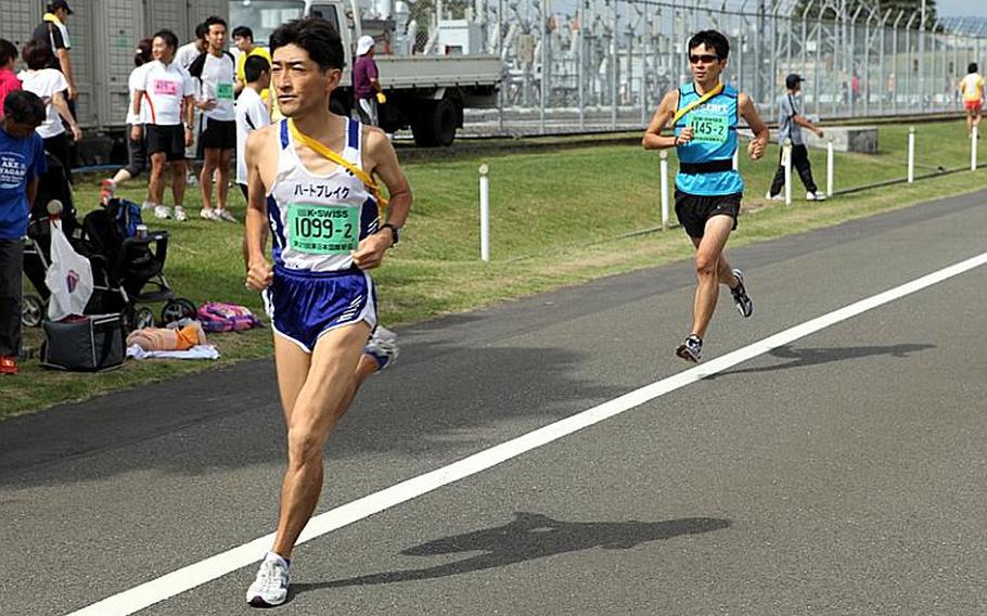 Runners keep up the pace as they run to complete the second part of a four-person relay during the 21st annual Ekiden relay race Sunday at Sagami General Depot.