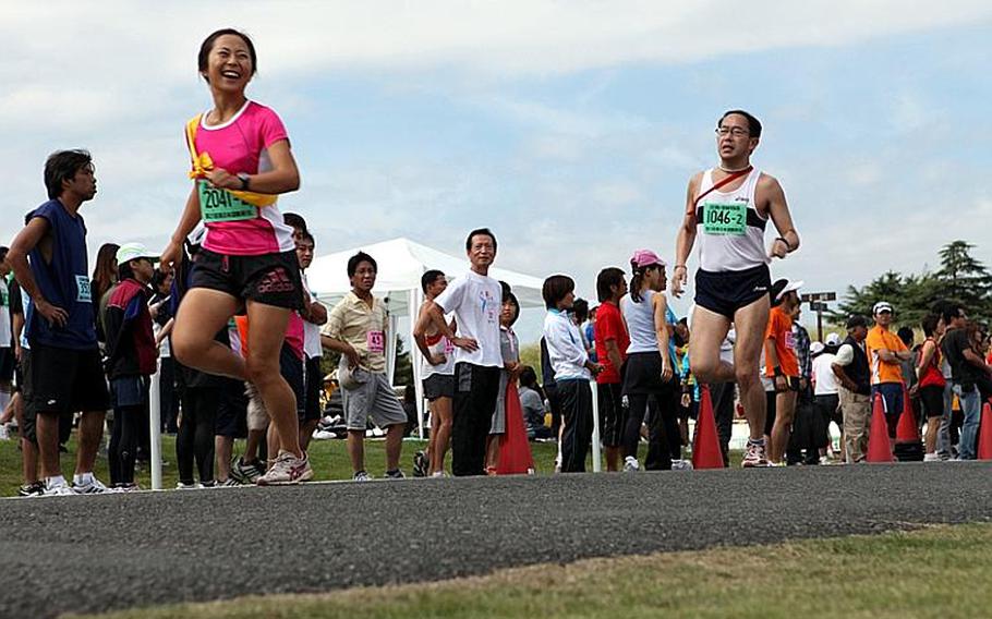 A Japanese runner enjoys her leg of the relay race during the 21st annual Ekiden Sunday at Sagami General Depot.