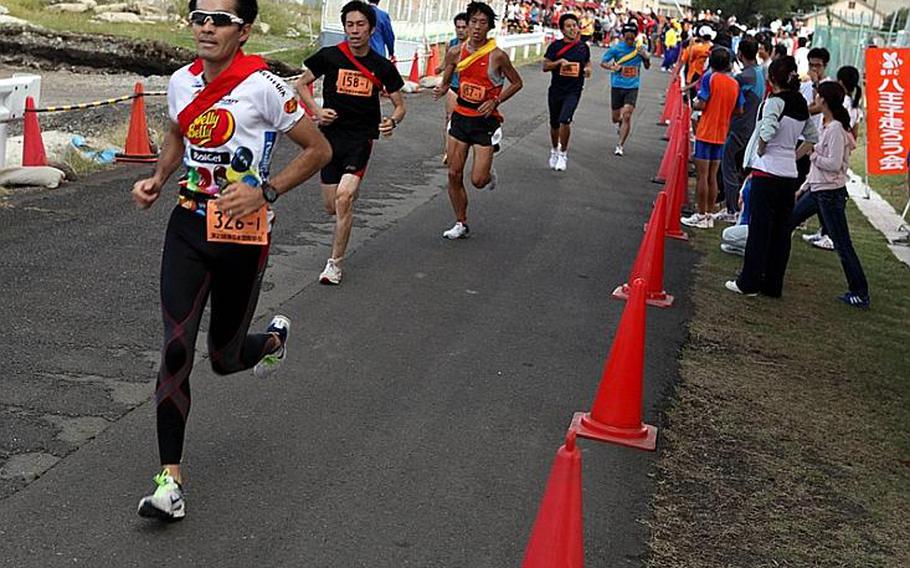 Runners take to the pavement at Sagami General Depot for the 21st annual Ekiden relay race, Sunday.