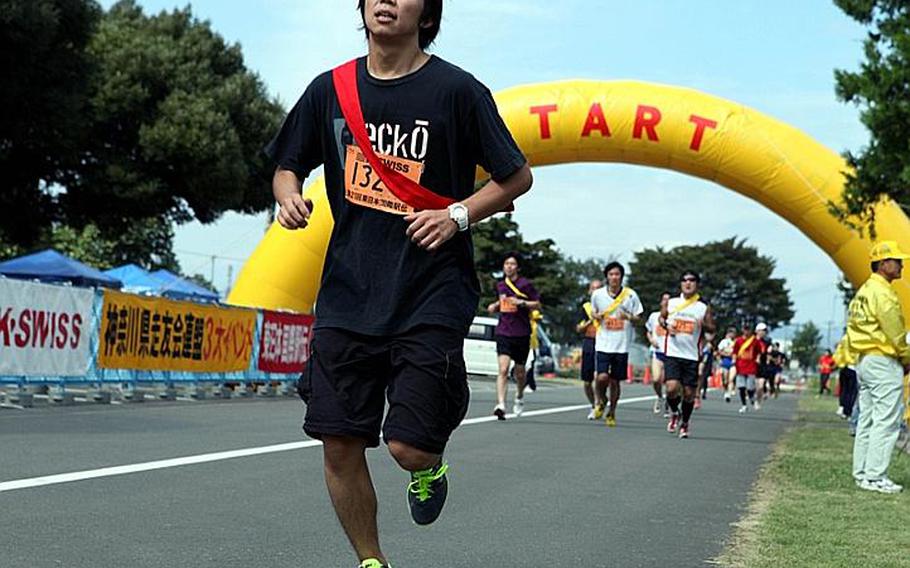 A runner pushes himself during the 21st annual Ekiden relay race Sunday at Sagami General Depot.