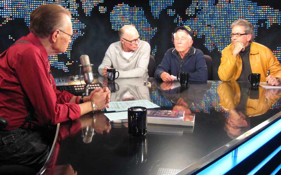 WWII veteran Leon Cooper, center, with actor Ed Harris, left, and filmmaker Steven C. Barber, right, appeared on Larry King Live in December to discuss Barber's documentary "Return to Tarawa: The Leon Cooper Story," which Harris narrated. Barber filmed the military's first mission to Tarawa to search for the remains of the hundreds U.S. troops who died in the 1943 battle but were never recovered.