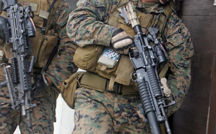Marines from Company C, 3rd Reconnaissance Battalion scope out their objective before entering - during training at Camp Fuji, Wednesday.