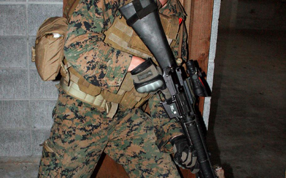 Oct. 20, 2010
A Marine from Company C, 3rd Reconnaissance Battalion   cautiously proceeds through a doorway during Military Operations in Urban Terrain training at Camp Fuji, Wednesday.