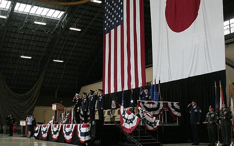 From left to right, Adm. Robert Willard, commander, U.S. Pacific Command, Gen. Gary North, commander, Pacific Air Forces, Lt. Gen. Edward Rice, outgoing U.S. Forces Japan commander, and Lt. Gen. Burton Field, incoming USFJ commander, take the stage Monday during a USFJ change of command ceremony at Yokota Air Base.